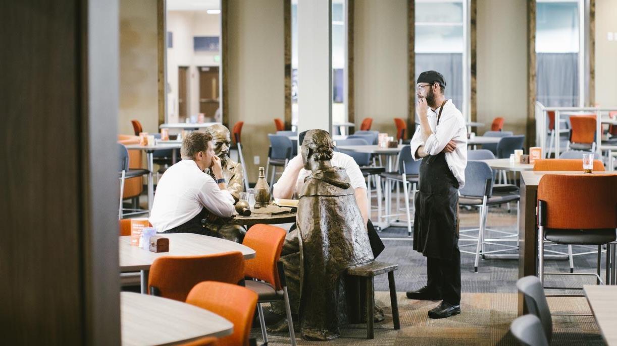 Three University of Mary chefs having a discussion in the Crow’s Nest Campus Restaurant.