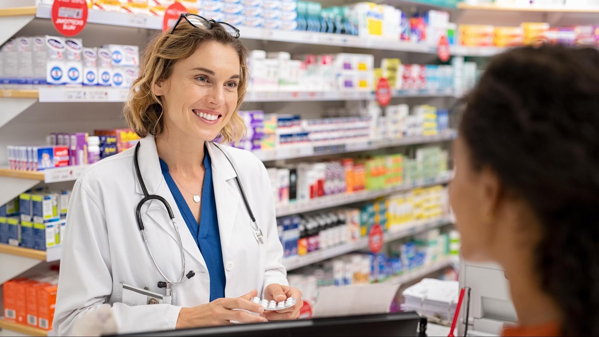 Pharmacist talking with customer